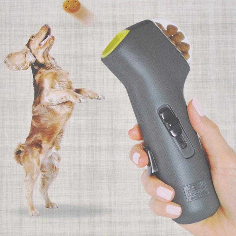 Dog catching treat launched from Pet Treat Launcher toy in motion