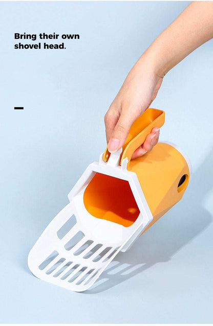 Cat using cat litter box scoop to clean litter box mess