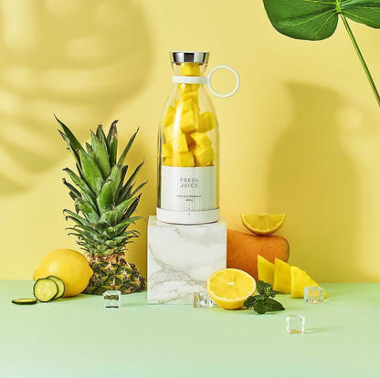 Portable blender bottle blending fresh fruit smoothie on the go, sleek and quiet design