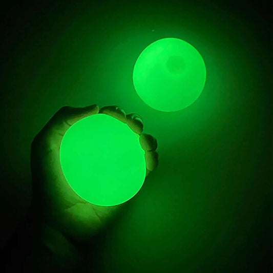 Sticky glow balls glowing in the dark, perfect for late night fun and easy to wash