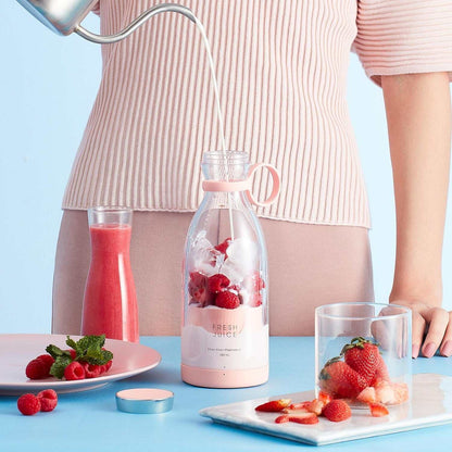 Portable sleek Blender Bottle blending fresh fruit smoothie on the go